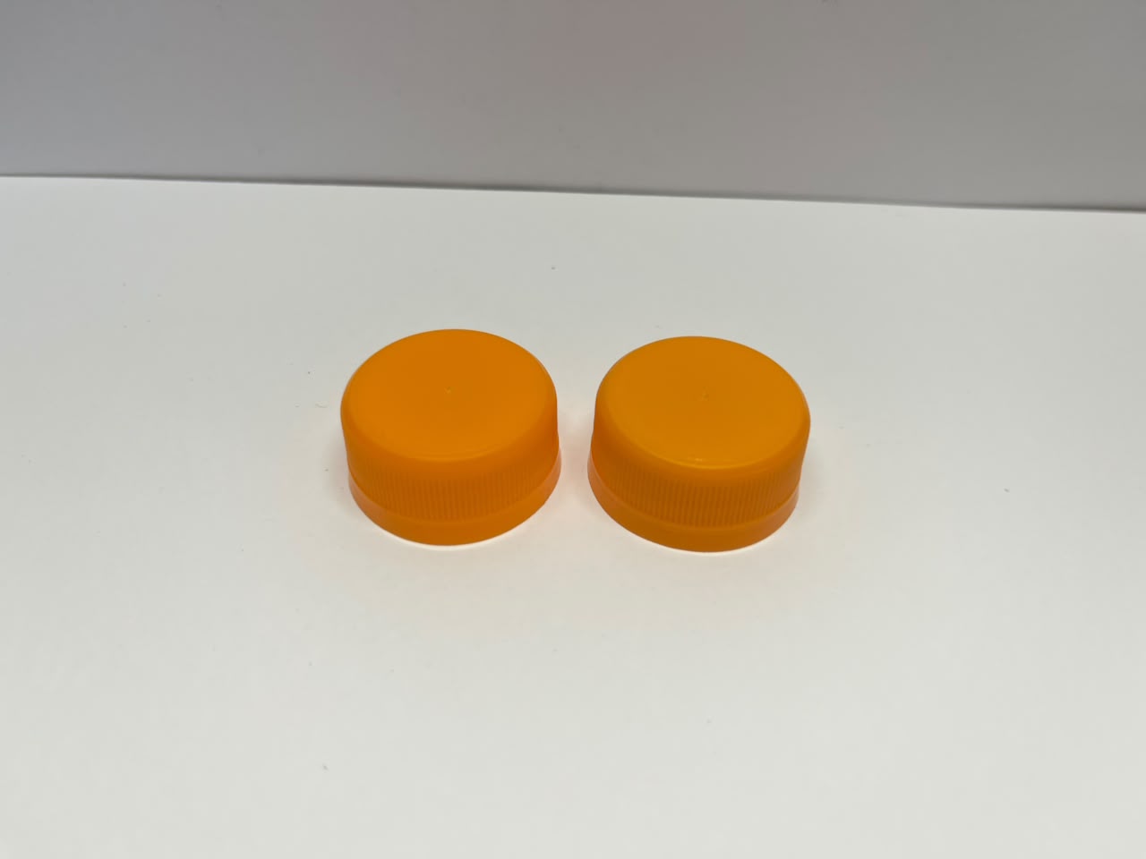 3 Star Alaska 28 mm caps arranged on table